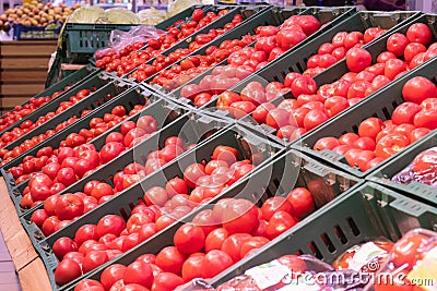 Showcase with tomatoes in a supermarket. A lot of red tomato. The choice of products. vegetables Stock Photo