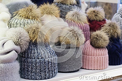 Showcase of trade tent with variety of women's hats with fur pom-poms Stock Photo