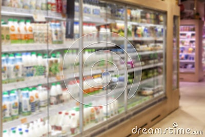 Showcases with products in a supermarket. Assortment of food. Blurred Stock Photo