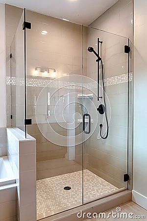 Shower stall with half glass enclosure and black shower head and handle Stock Photo