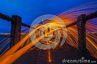 Showers of hot glowing sparks from spinning steel wool. Stock Photo