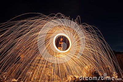 Showers of hot glowing sparks from spinning steel wool Stock Photo