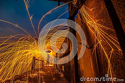 Showers of hot glowing sparks from spinning steel wool. Stock Photo