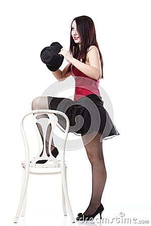 Showgirl woman dance in red corset chair Stock Photo