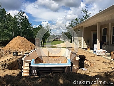 In ground residential swimming pool construction. Prefab walls. Stock Photo