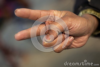 Showing two fingers like devil horns and the background blur Stock Photo