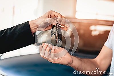 Showroom Dealer The Gives Car Keys To The Buyer. Stock Photo