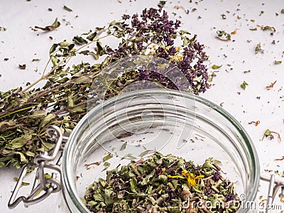 Shredded dried oregano in a glass jar. Closeup view Stock Photo