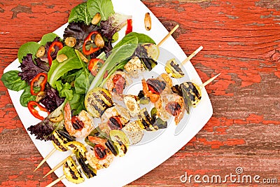 Shrimp Skewers on Plate with Veggies and Spices Stock Photo