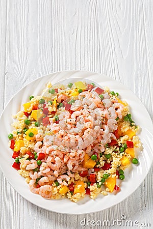 Shrimps and millet pilaf with mango and veggies Stock Photo