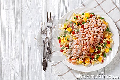 Shrimps and millet pilaf with mango and veggies Stock Photo