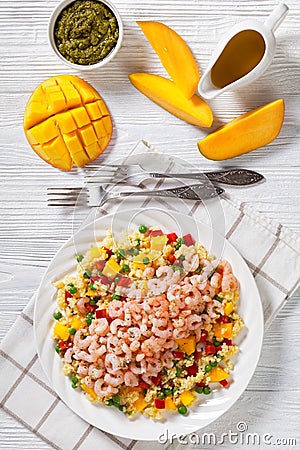 Shrimps and millet pilaf with mango and veggies Stock Photo