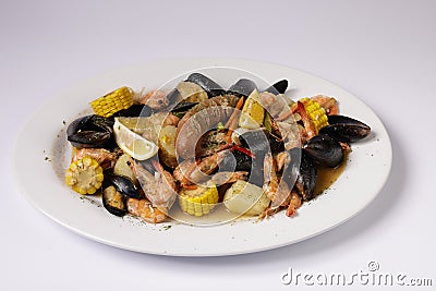 SHRIMPS AND MUSSELS CLAWDADDY BOIL in dish top view on grey background singapore food Stock Photo