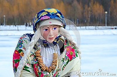Shrovetide doll in colorful shawls, shirt and fur sleeveless jacket Stock Photo