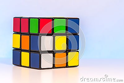 Shuffled Magic Cube for problem-solving on light blue background Editorial Stock Photo