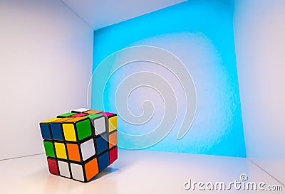 Shuffled Rubik`s Cube inside a cube with light blue background Editorial Stock Photo
