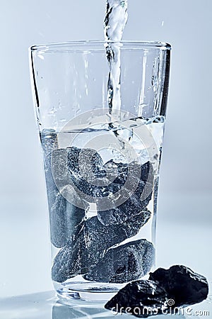 Shungite stones being used to purify water Stock Photo