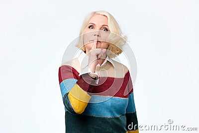 Serious lovely blonde woman asks to keep secret information confidential Stock Photo