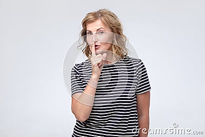 Serious lovely female asks to keep secret information confidential Stock Photo