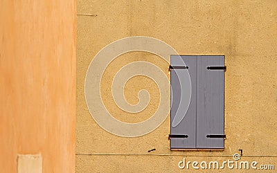 Shutter on colorful wall. Provence. Stock Photo