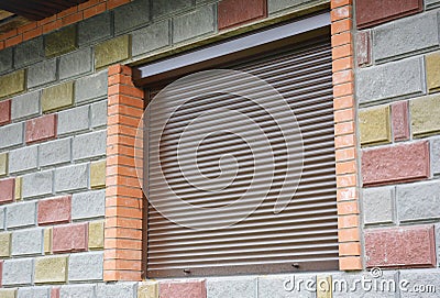 Shutter security barrier. Window with rolling shutter for house protection. Security Shutters Grilles. Stock Photo