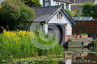 Shuttered boathouse on the Lancaster Canal, UK Editorial Stock Photo