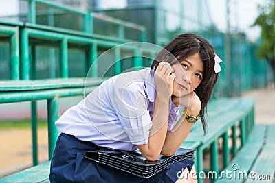 Shy Asian Thai schoolgirl student in high school uniform educati Stock Photo