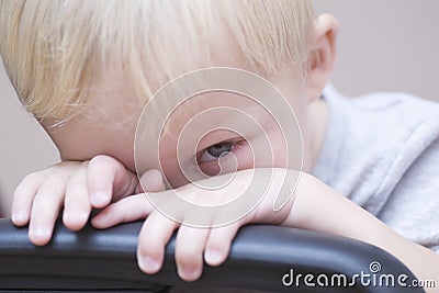 Shy Baby Boy Peeking Over Chair Stock Photo