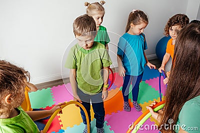 Shy boy learning to interact with kids at daycare Stock Photo