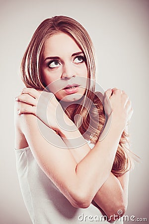 Shy girl, afraid woman on gray Stock Photo