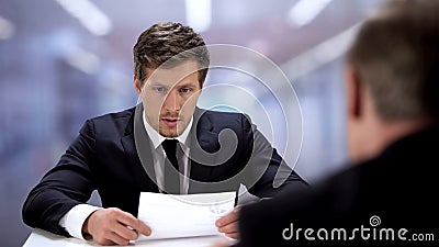 Shy man unconfidently presenting himself to new job position, lack of experience Stock Photo