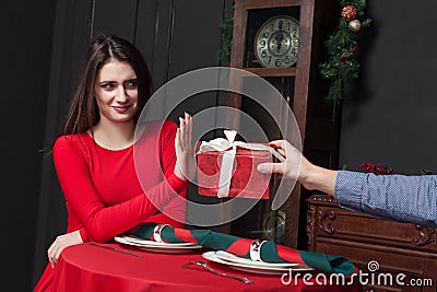 Shy woman refuses gift in restaurant Stock Photo