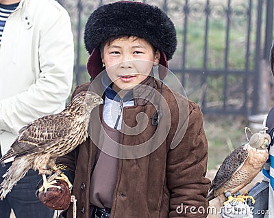 Shymkent, KAZAKHSTAN - 22 March 2017: People Celebrating the Kazakh holiday NARIYZ. Boy with a hawk Editorial Stock Photo