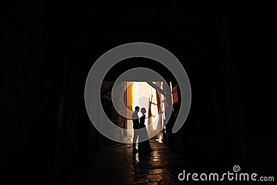 Sibenik, Croatia - 05.06.17: Groom holds bride's hands, standing in the shadow of the courtyard of the old house in Editorial Stock Photo