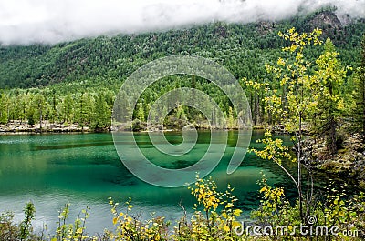 Siberia. Beautiful green fog lake in the forest. Buryatia Stock Photo