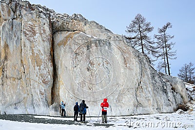 Siberia, Irkutsk region, cape Sagan-Zaba, Russia, March, 10, 2017.Tourists walking near the rocks of Cape Sagan-Zaba in cloudy wea Editorial Stock Photo