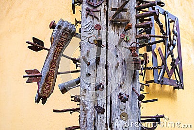 Segment of the Journeymen Pillar Casa Calfelor showing a wooden hand with metallic arrows through it Editorial Stock Photo