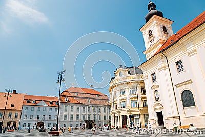 Holy Trinity Roman Catholic Church and city hall at Piata Mare Large Square in Sibiu, Romania Editorial Stock Photo