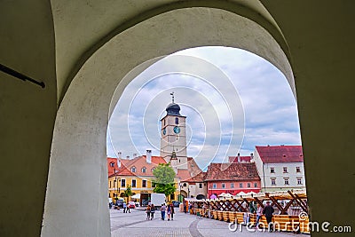 The Council Tower Turnul Sfatului seen from under a passage arch of Arts House - Butchers Guild Hall in Sibiu - horizontal Editorial Stock Photo