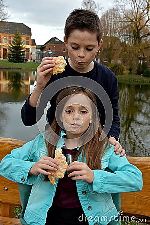 Siblings eating cake Stock Photo