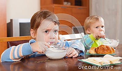 Siblings eating dairy breakfast Stock Photo