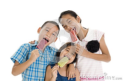 Siblings eating ice creams Stock Photo