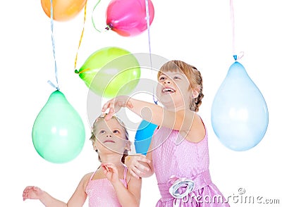 Siblings playing with balloons Stock Photo