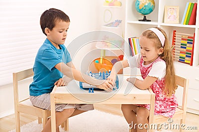 Siblings playing chess in the kid's room Stock Photo