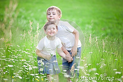 Siblings playing in field Stock Photo