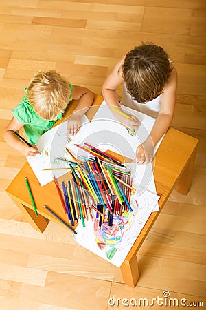 Siblings playing with pencils Stock Photo