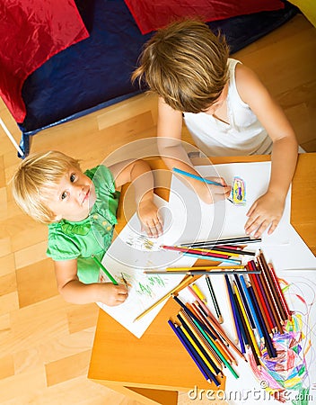 Siblings playing with pencils Stock Photo