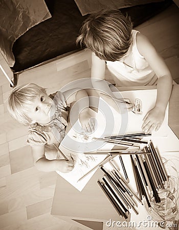 Siblings playing with pencils Stock Photo
