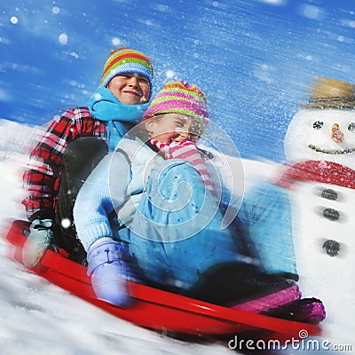 Siblings Playing Snow Sledge In The Snow Concept Stock Photo