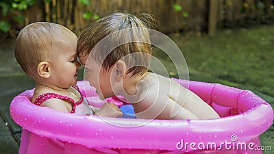 Siblings playing in a tub Stock Photo